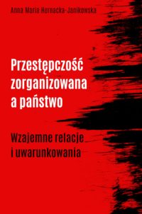 Czerwone tło, czarne i białe litery, czarne mazańce z prawej strony